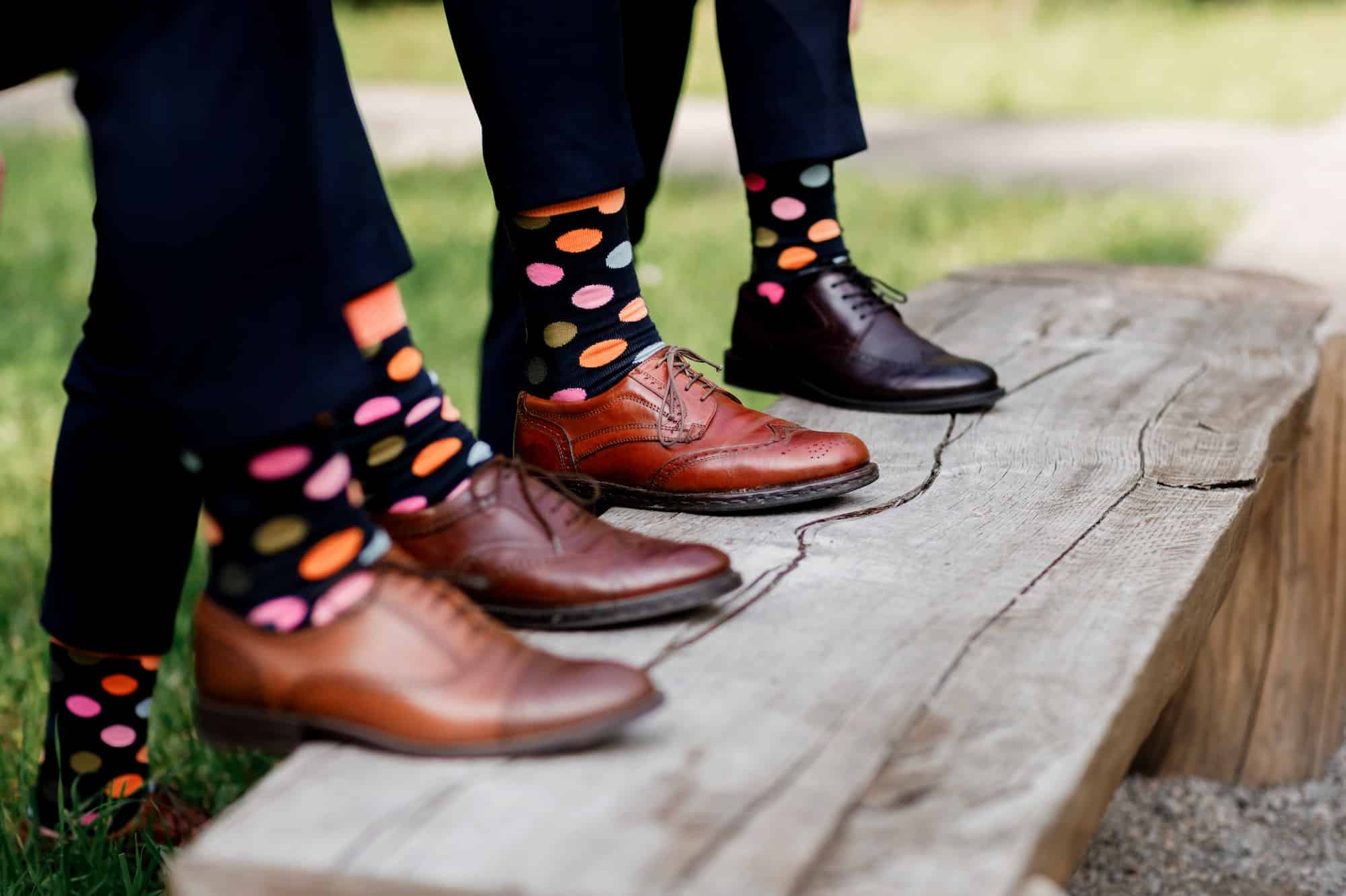 Feet of the groom and friends of the groom with funny colored socks. Men in colorful socks