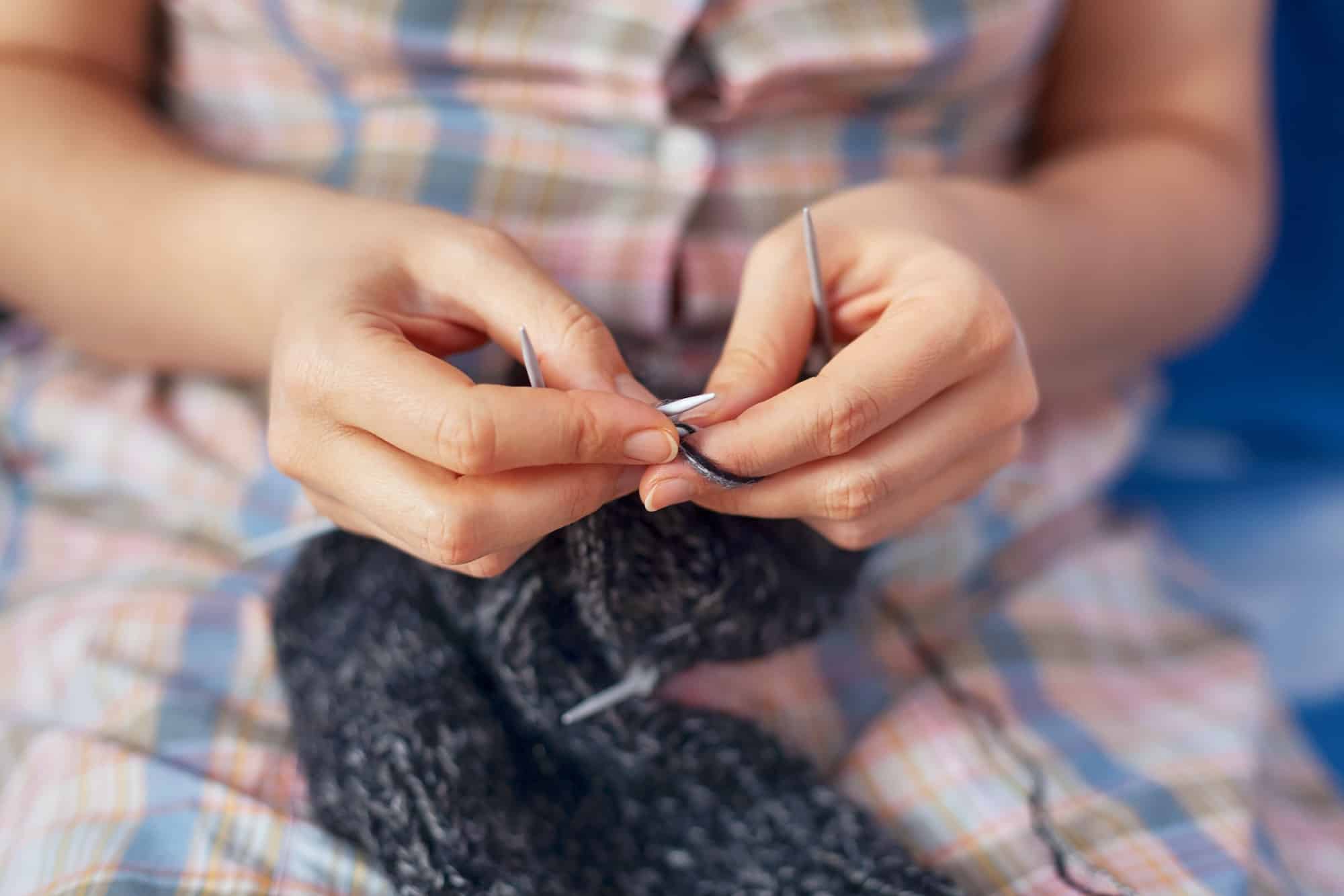 Woman knitting wool socks
